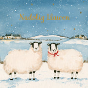 Nadolig Llawen — Defaid / Welsh card featuring two sheep in a snowy landscape