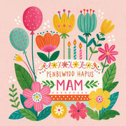 Penblwydd Hapus Mam — Cacen a blodau / Welsh card featuring a birthday cake, colourful flowers and balloons on a pink background