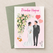 Cerdyn Priodas Hapus gyda phâr priodasol, blodau a balŵns, yn wastad gydag amlen werdd / Welsh wedding card shown flat with a green envelope.